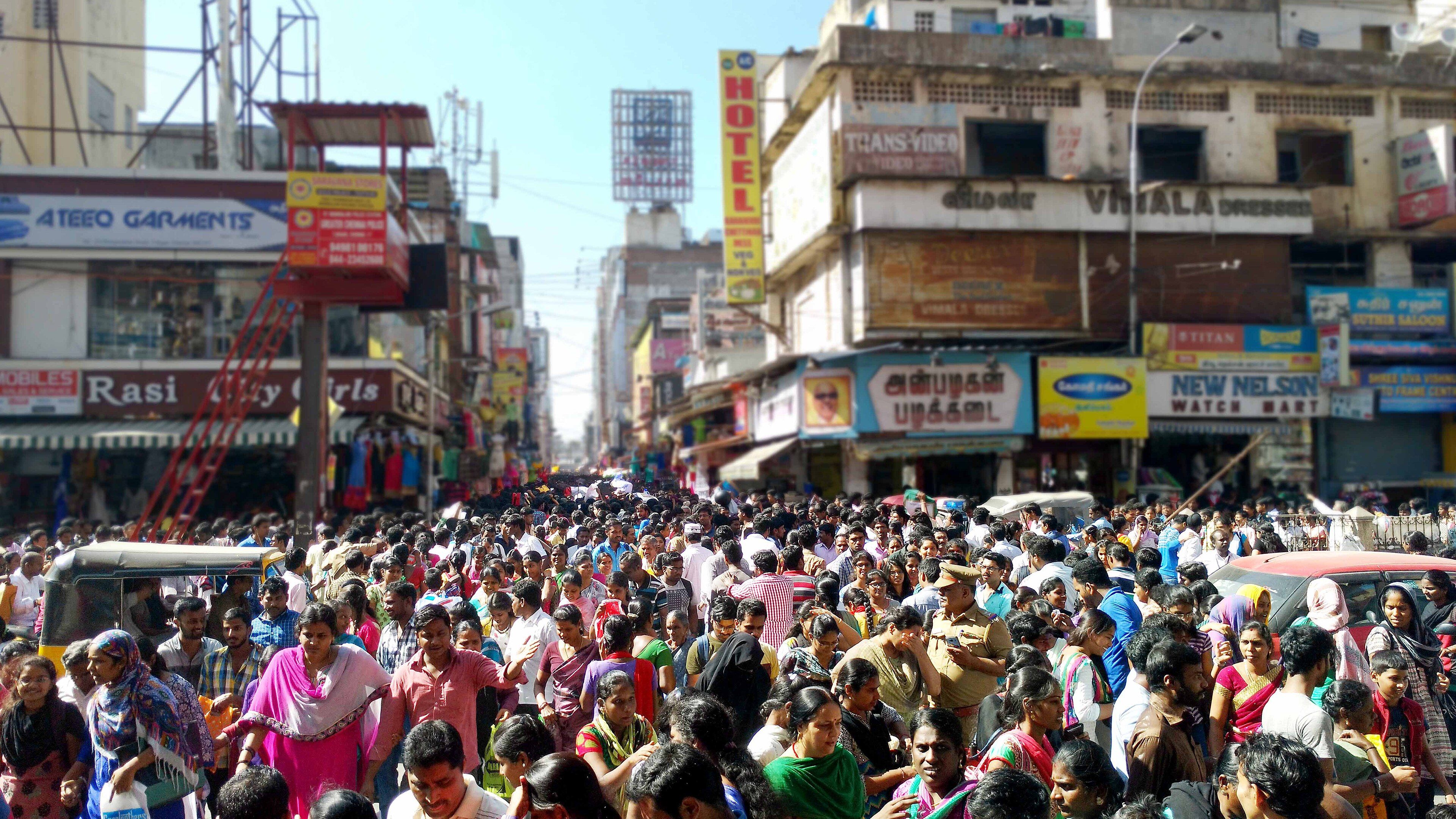 Diwali shoppers fill a T. Nagar street under rows of shop signboards